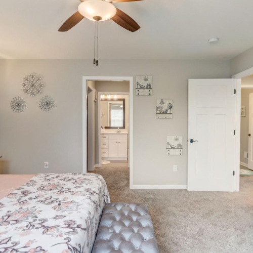 a bedroom with a ceiling fan