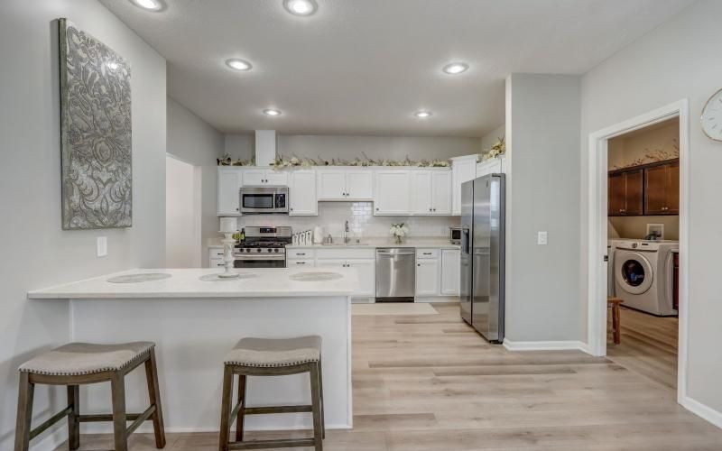 a kitchen with white cabinets